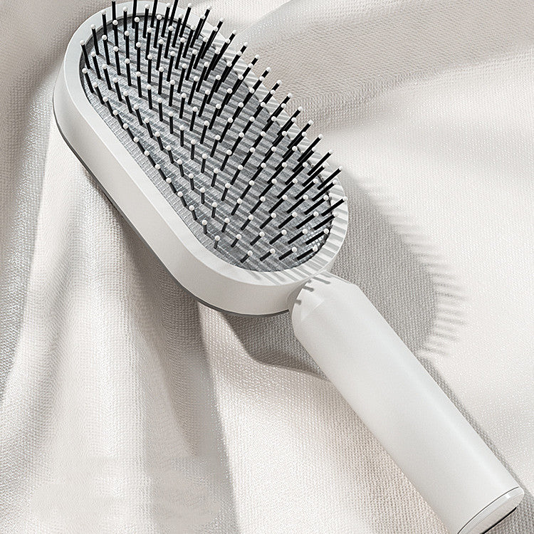 Èvoque self-cleaning detangling paddle brush one-button release